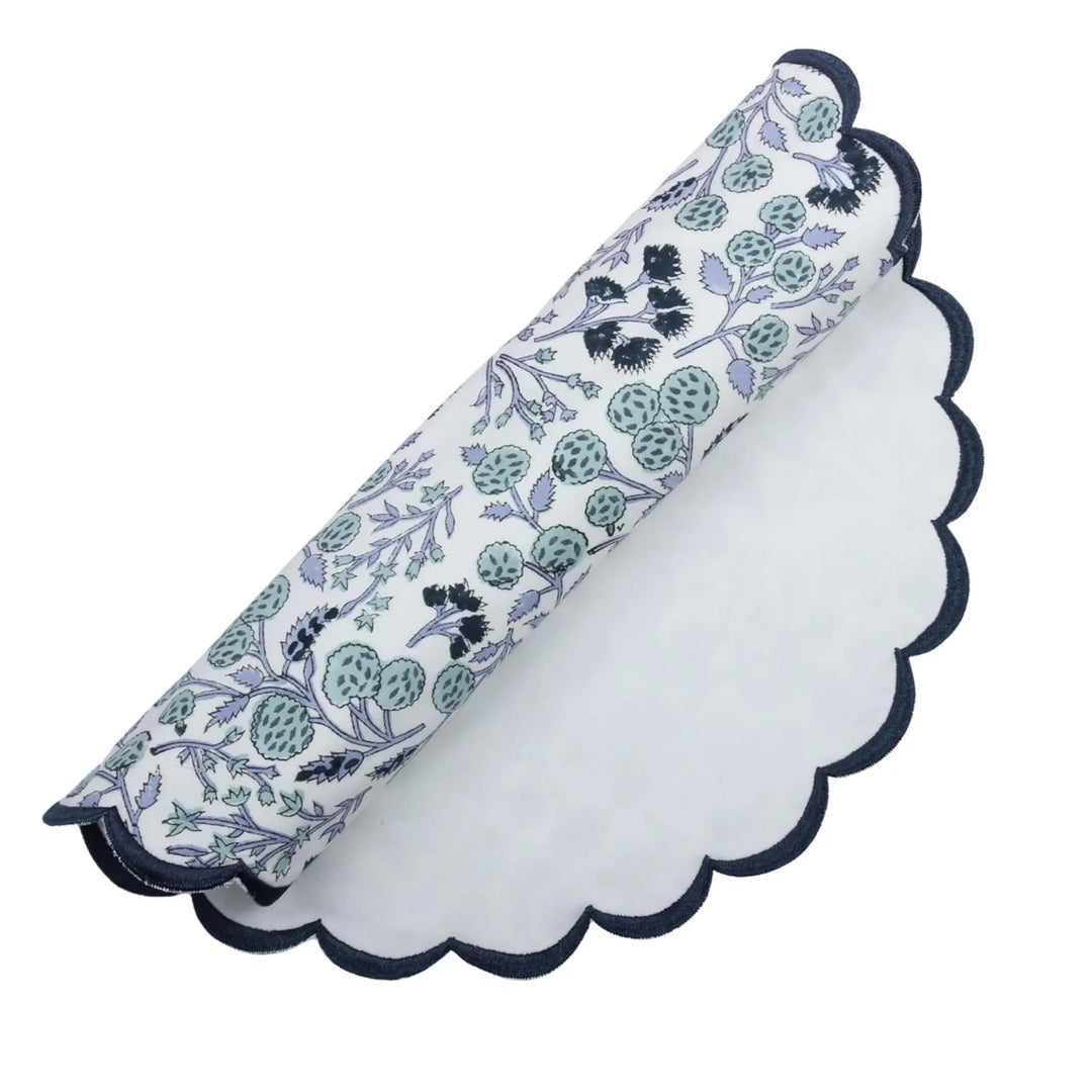 Floral-patterned napkin with scalloped edge on a white background