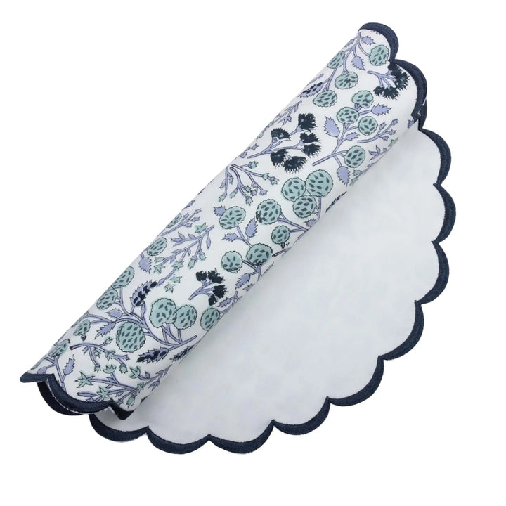 Floral-patterned napkin with scalloped edge on a white background
