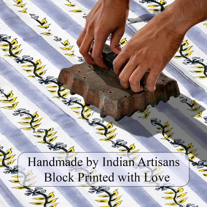 Hand block printing on fabric with text 'Handmade by Indian Artisans Block Printed with Love'.