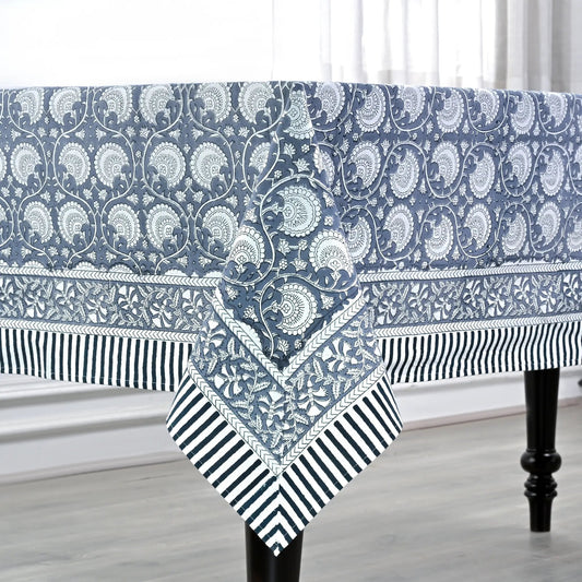 Blue and white patterned tablecloth on a dining table with a neutral background