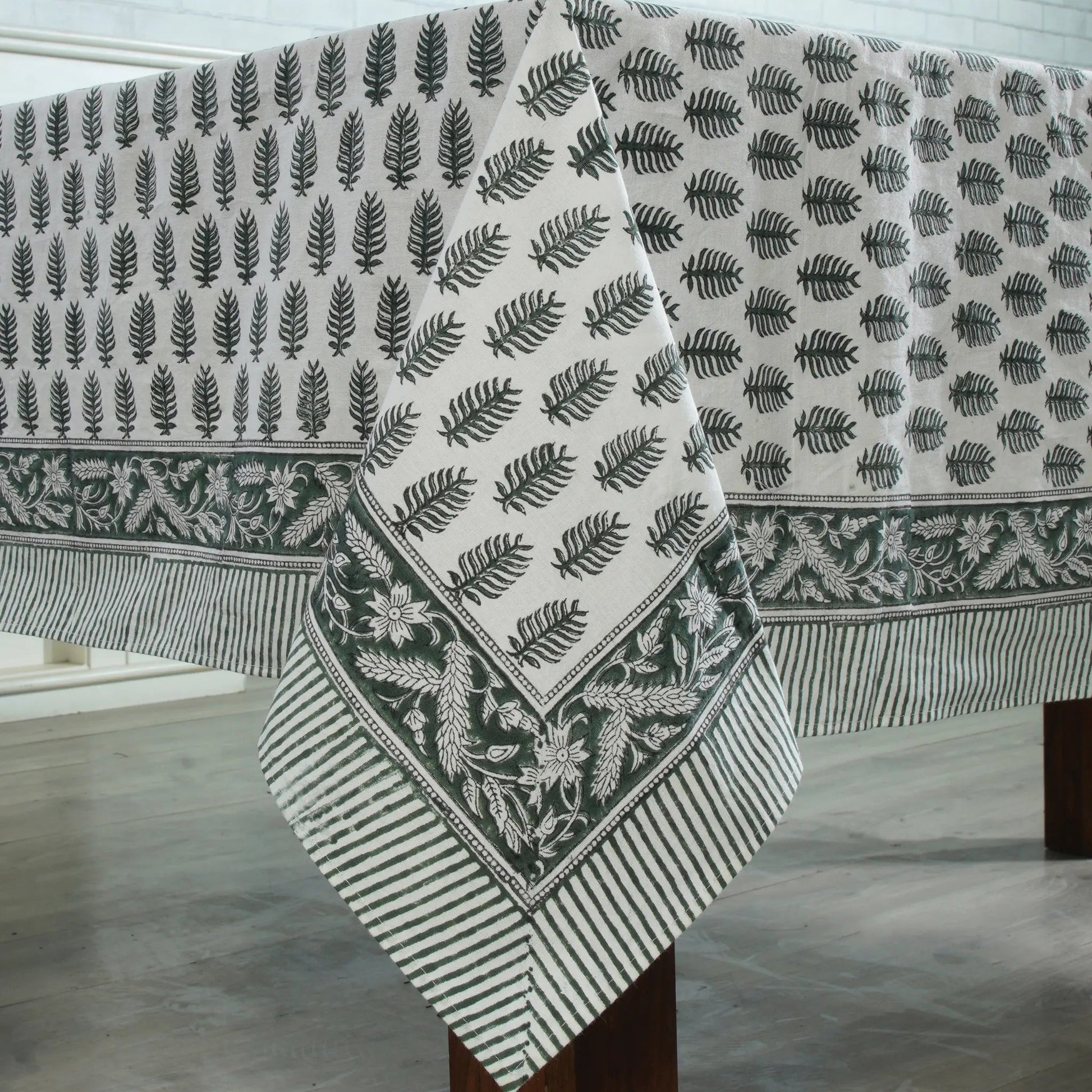 Fabric with leaf pattern draped over a wooden surface