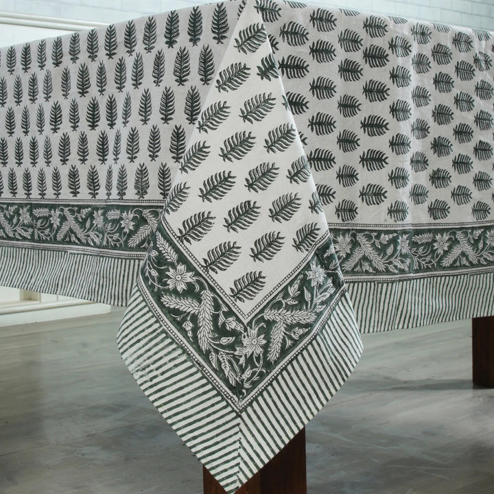 Fabric with leaf pattern draped over a wooden surface