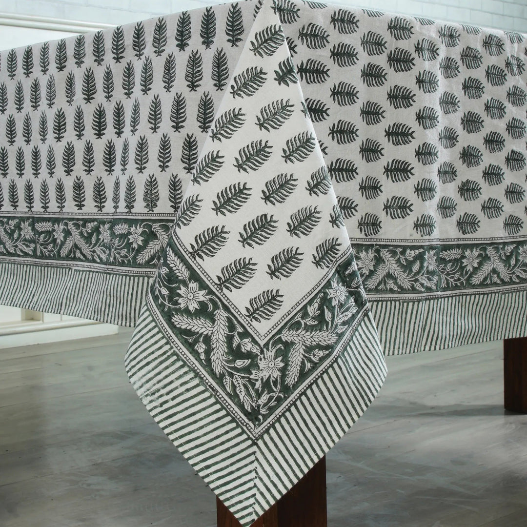 Fabric with leaf pattern draped over a wooden surface