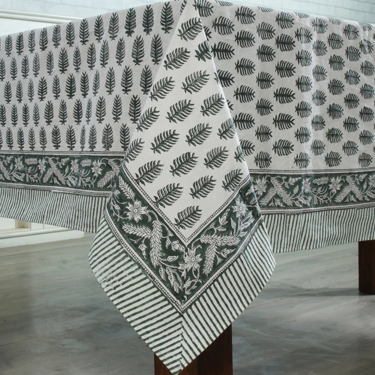 Fabric with leaf pattern draped over a wooden surface