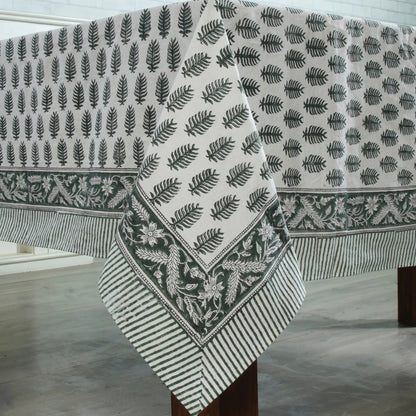 Fabric with leaf pattern draped over a wooden surface