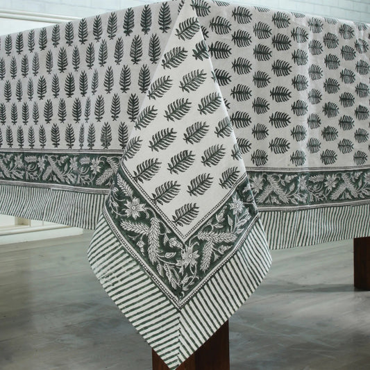 Fabric with leaf pattern draped over a wooden surface