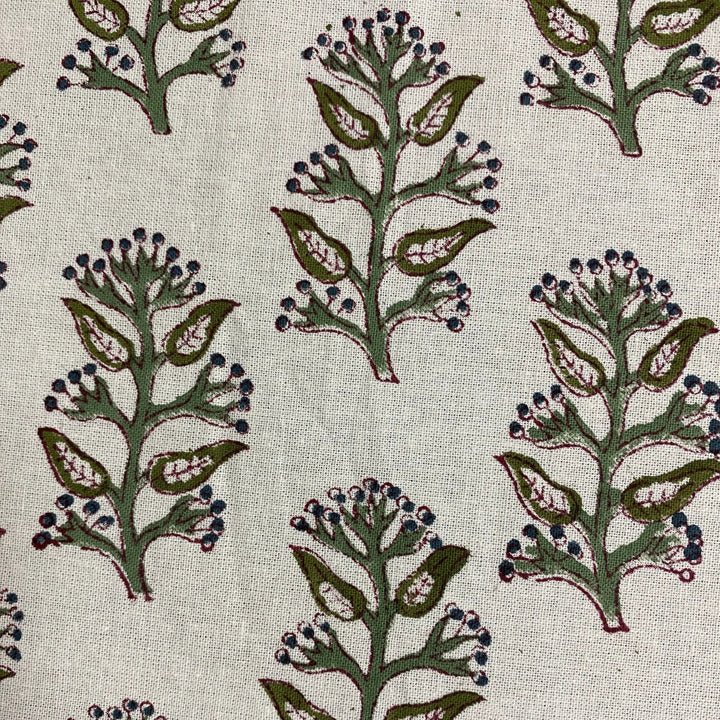 Pattern of green leaves and blue berries on a beige background