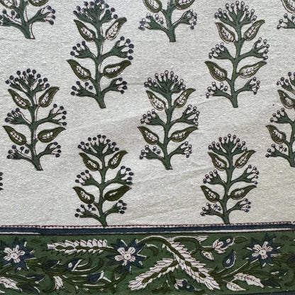 Patterned fabric with green floral design on a light background
