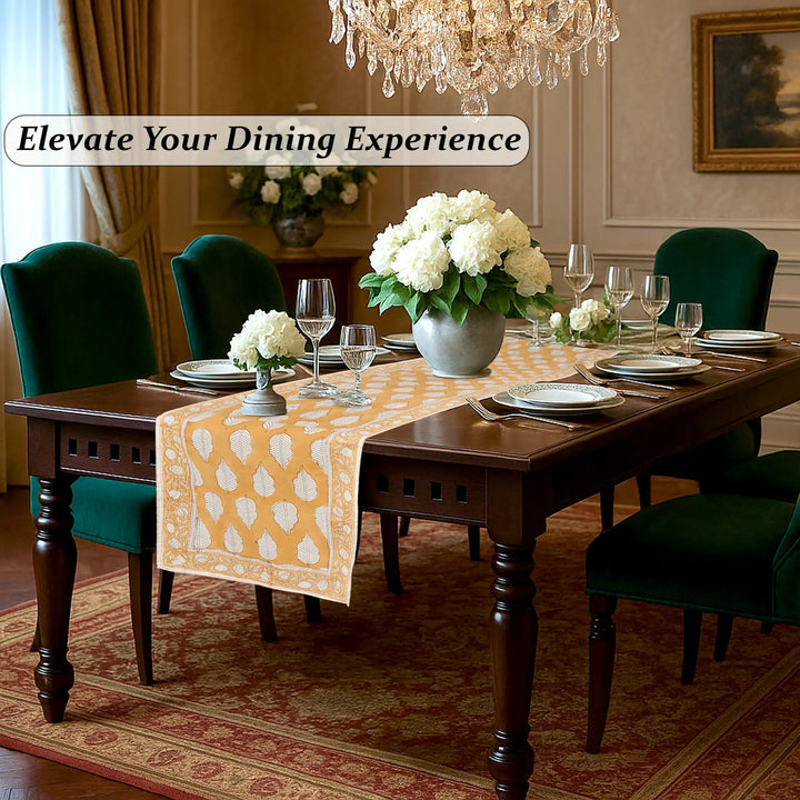 Dining room with a table set for dinner, flowers, and a chandelier.