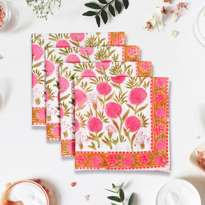 Set of floral patterned napkins on a white surface with decorative elements.