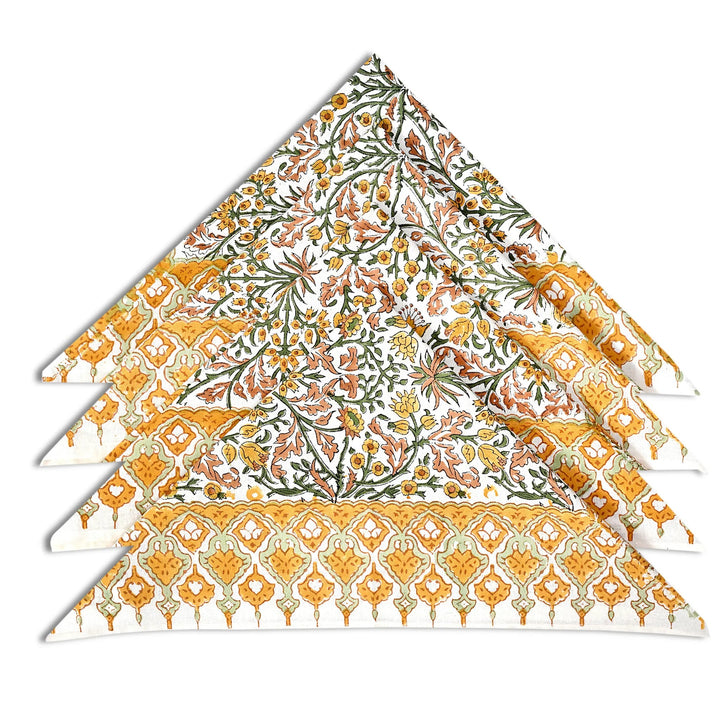 Set of four floral-patterned napkins on a white background