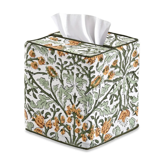 Floral patterned tissue box cover with tissues inside on a white background