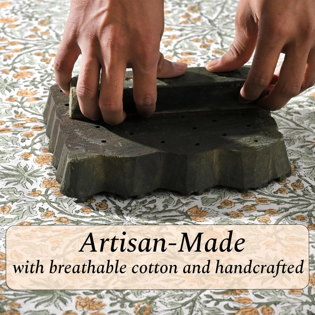 Hands holding a stack of artisan-made stone slabs with text on a patterned fabric background