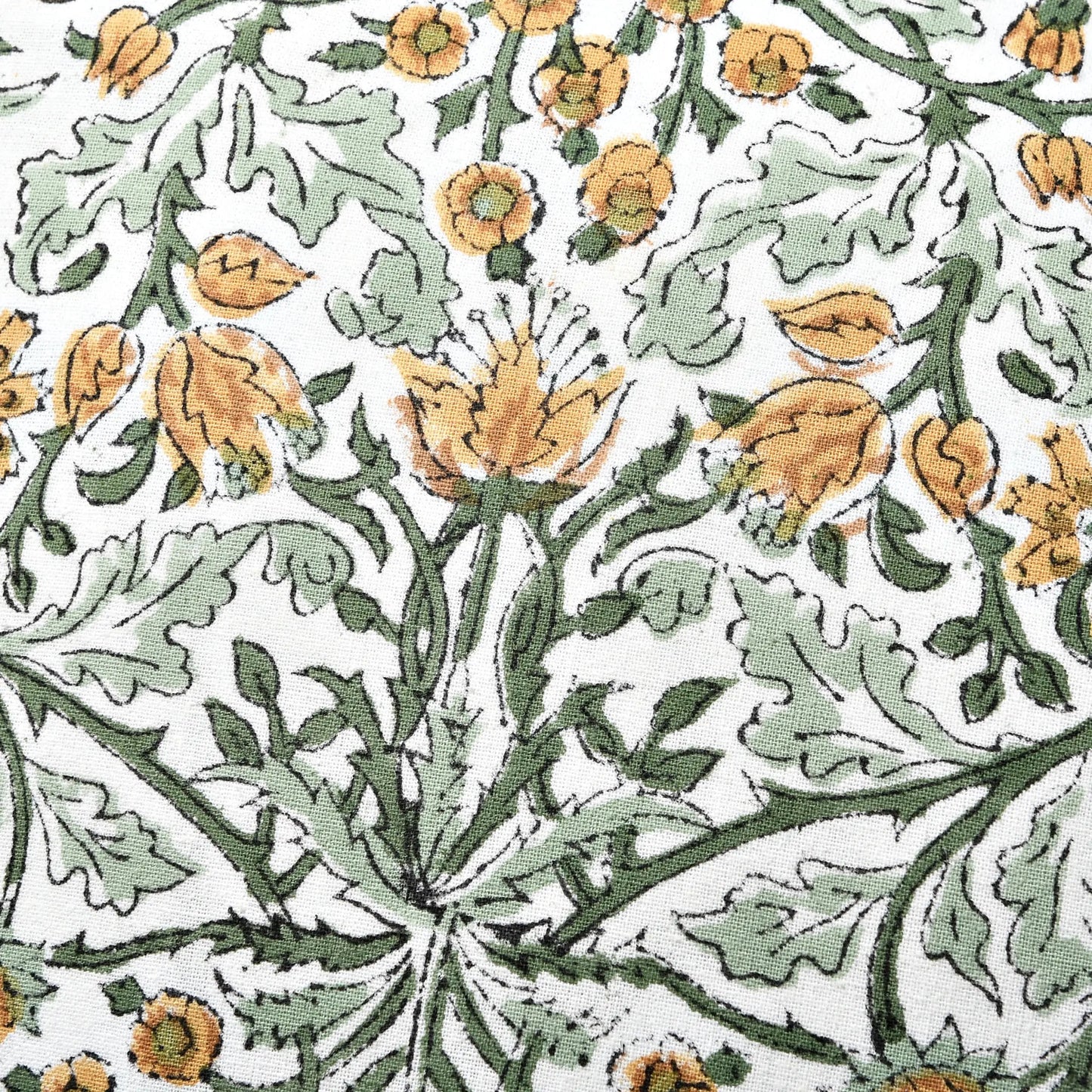 yellow floral Indian hand block print cotton fabric pattern close-up.