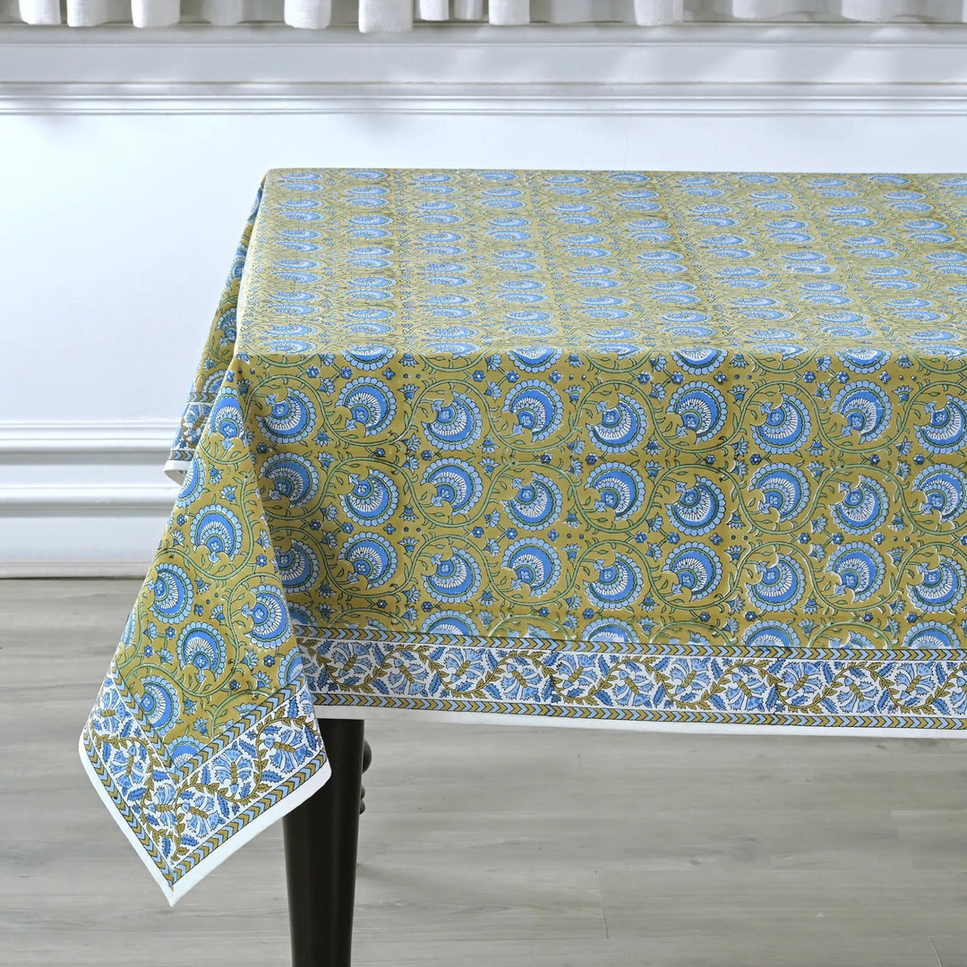 Tablecloth with blue and green pattern on a wooden table