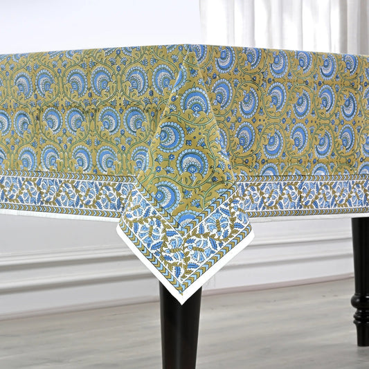 Patterned tablecloth on a table with a white curtain background
