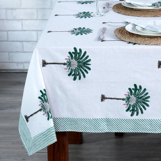 Tablecloth with green floral patterns on a wooden table