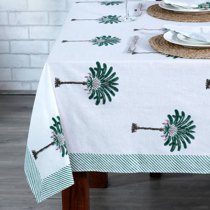 Tablecloth with green floral patterns on a wooden table