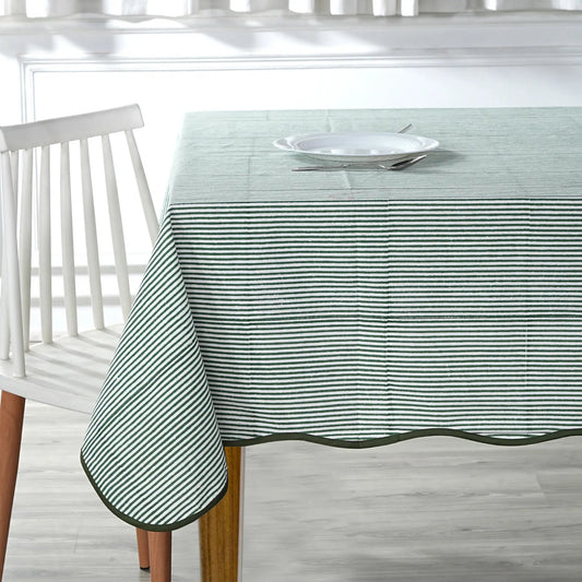 Tablecloth with green stripes on a wooden table and white chair