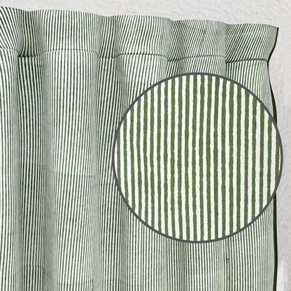 Green and white striped fabric with a close-up of a circular section.