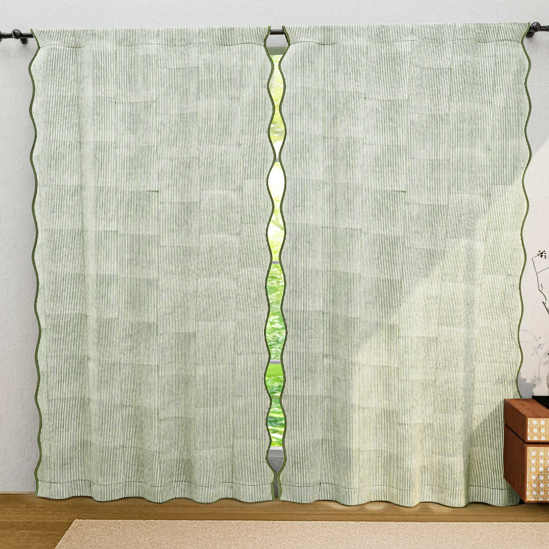 Green curtain with a decorative panel on a white wall