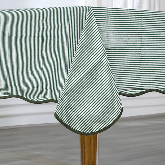 Green and white striped tablecloth on a wooden table with a neutral background