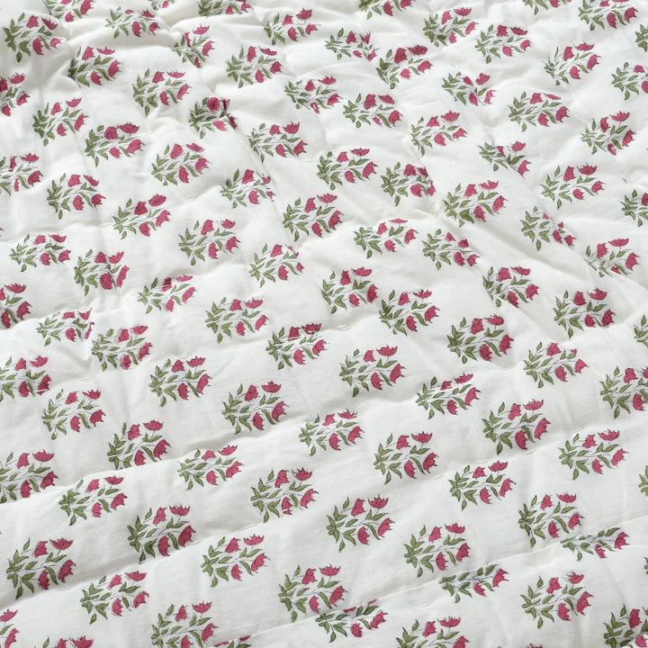 Floral patterned fabric with pink and green flowers on a white background