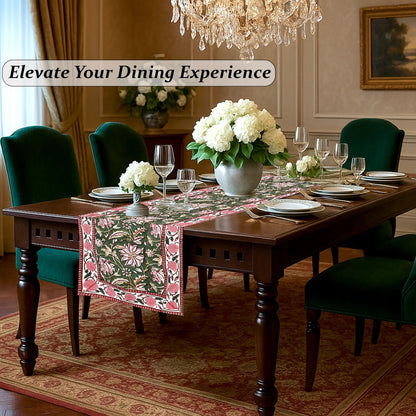 Dining room with a table set for dinner, flowers, and a chandelier.