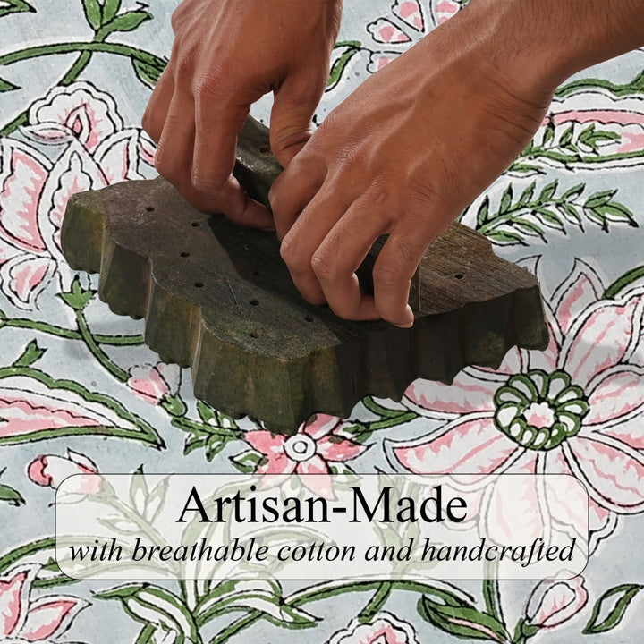 Hands using a wooden tool on a floral fabric background with &