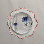 White linen round table mats with scallop edges in orange for table decor