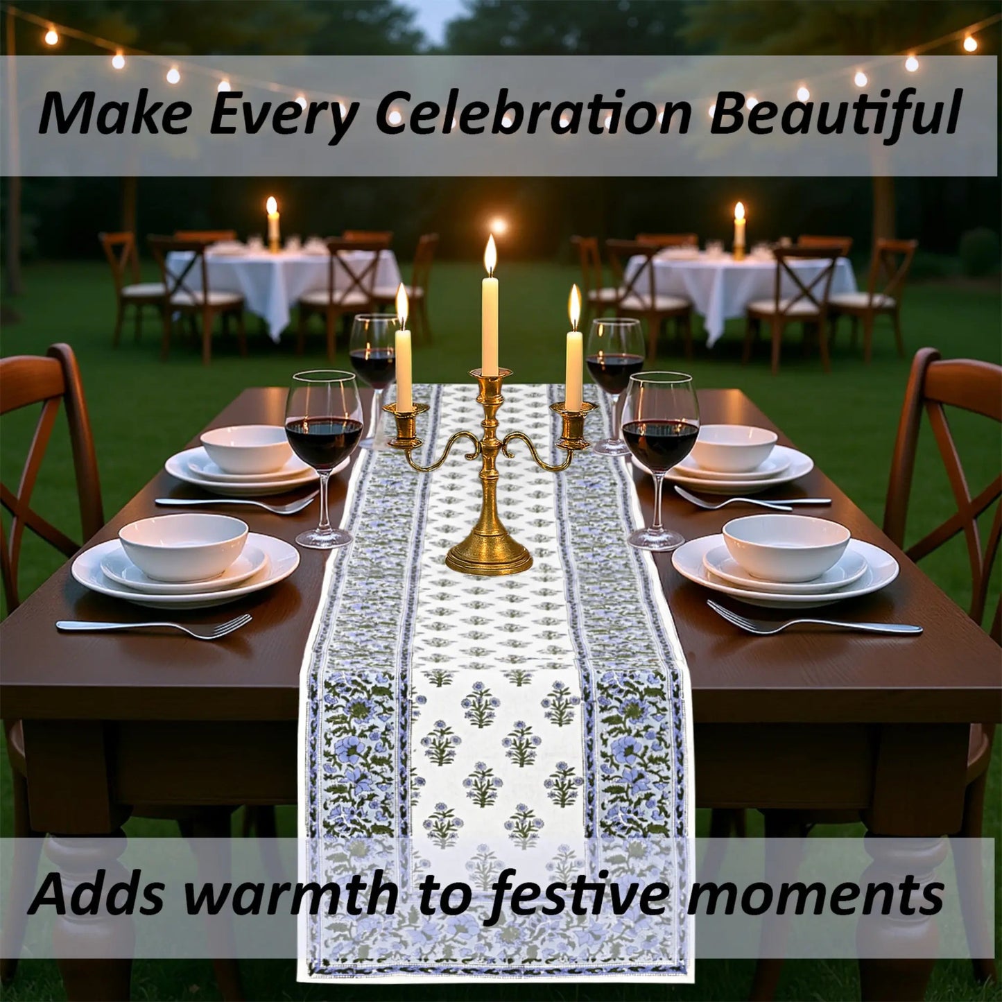 Dining table set with a decorative tablecloth, candles, and wine glasses outdoors.