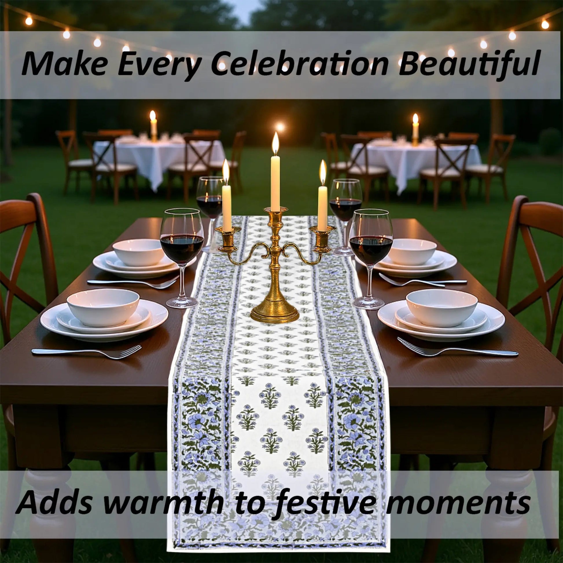 Dining table set with a decorative tablecloth, candles, and wine glasses outdoors.