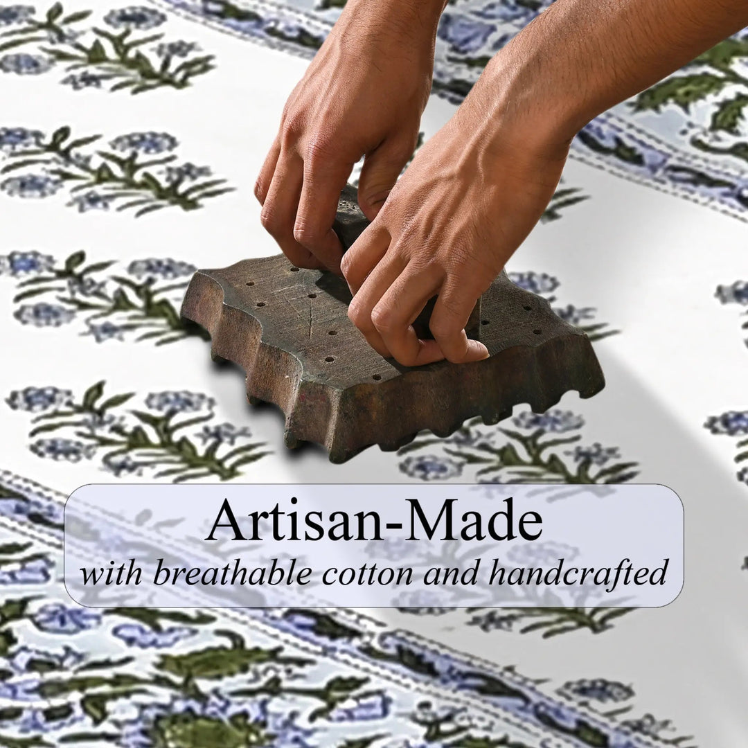 Person using a wooden block to print floral patterns on fabric, with text &