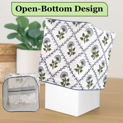 Floral-patterned towel with open-bottom design on a wooden surface, with a plant in the background.