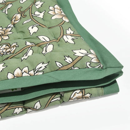 Green fabric with floral pattern on a white background