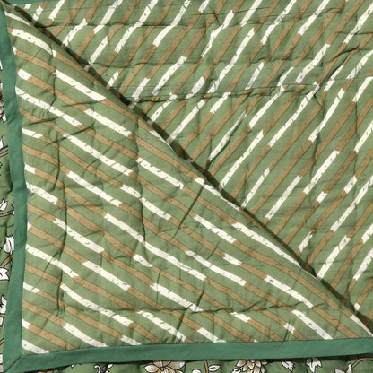 Green and white striped fabric with a floral pattern underneath