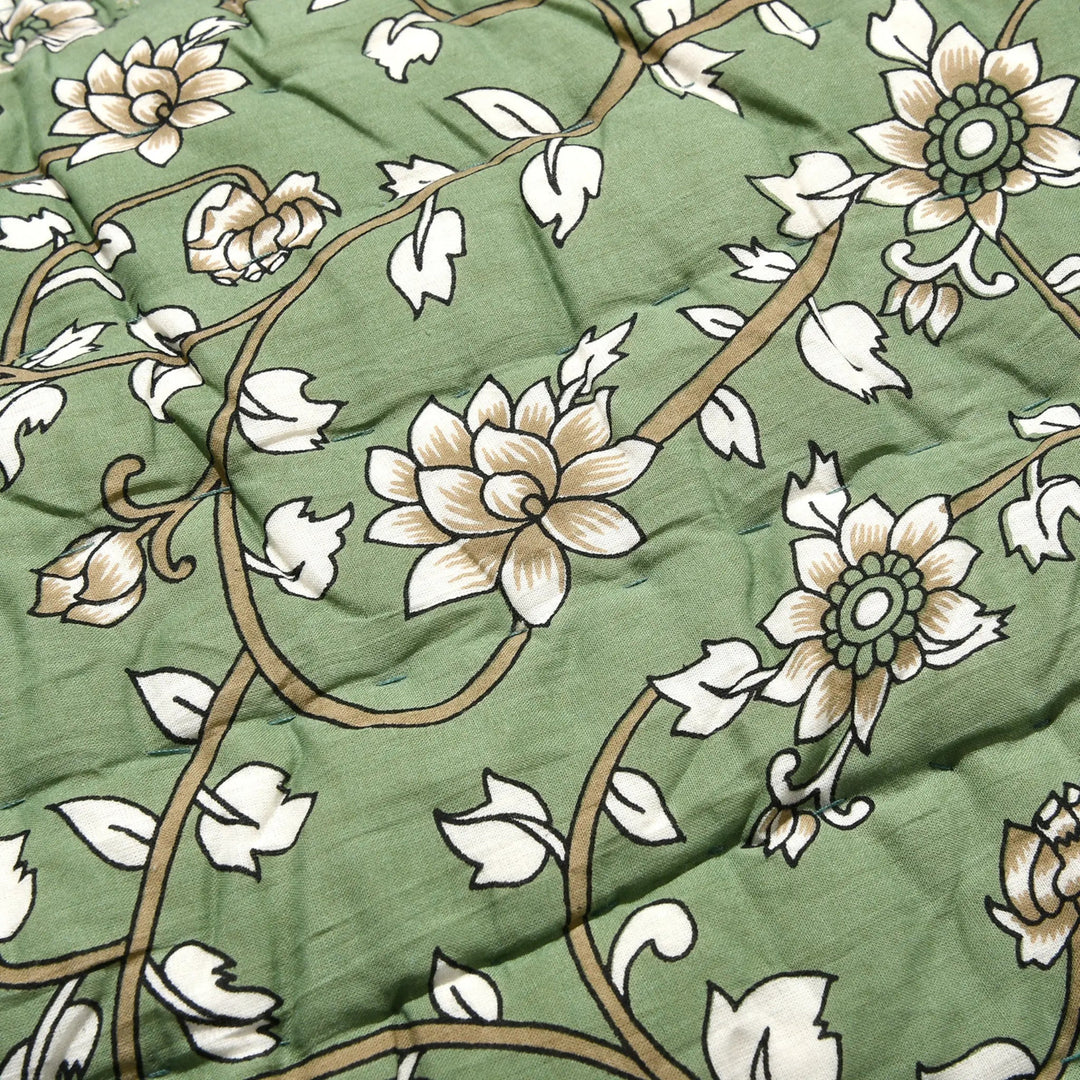 Floral patterned fabric with white flowers on a green background