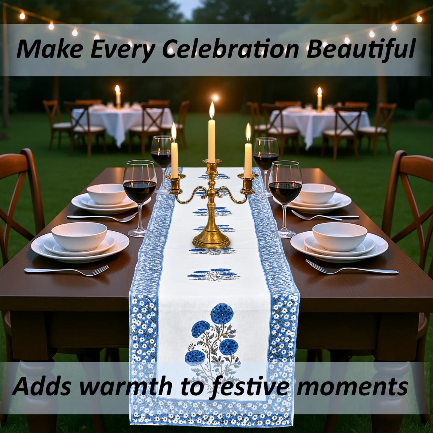 Dining table set with a floral table runner, candles, and wine glasses outdoors.
