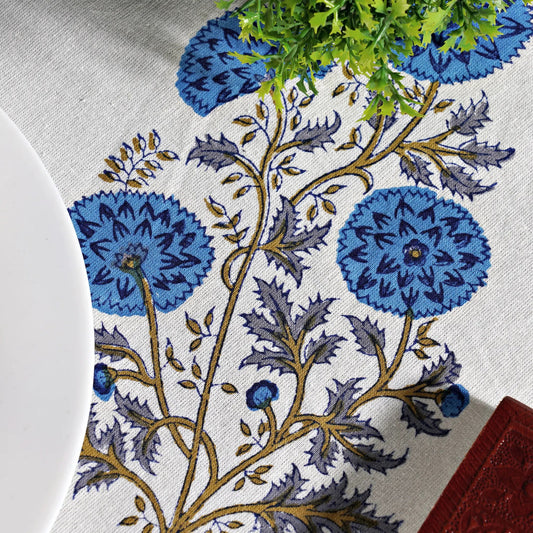 Floral patterned tablecloth with blue flowers on a white background
