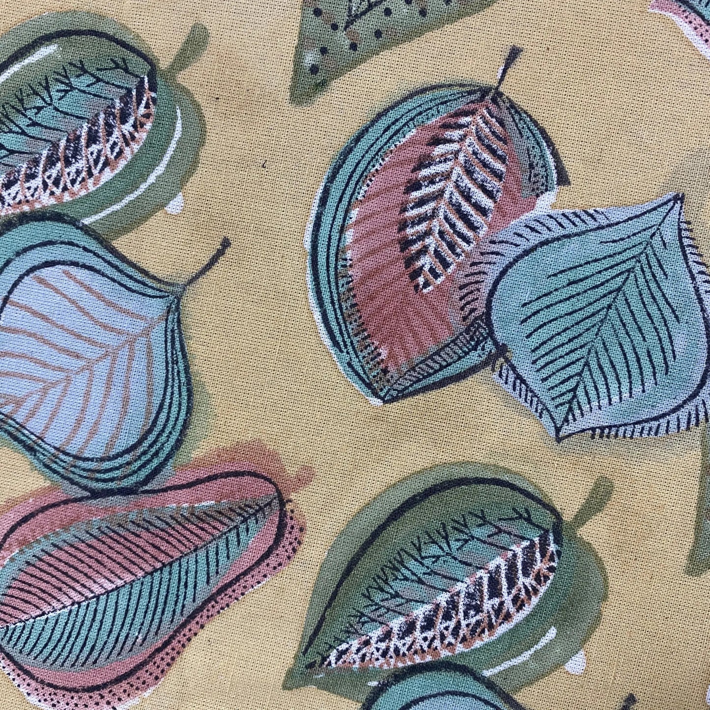 Embroidered leaf patterns on a fabric background