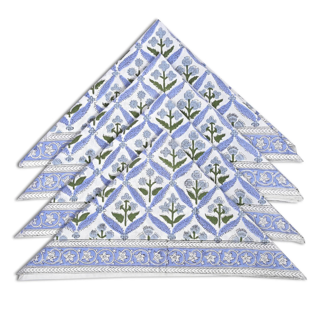 Set of six floral patterned napkins stacked on a white background