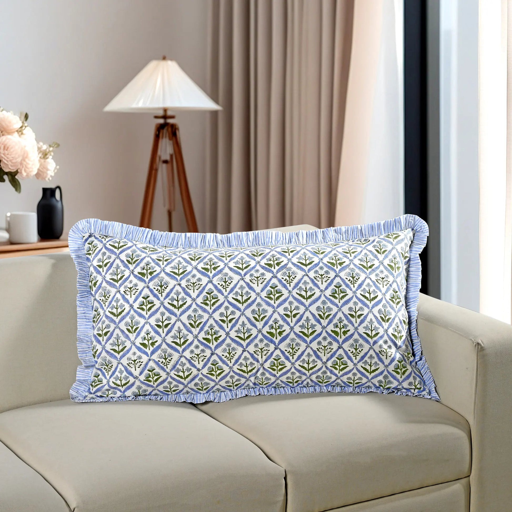Blue floral block print cotton pillow styled on a beige sofa in living room.