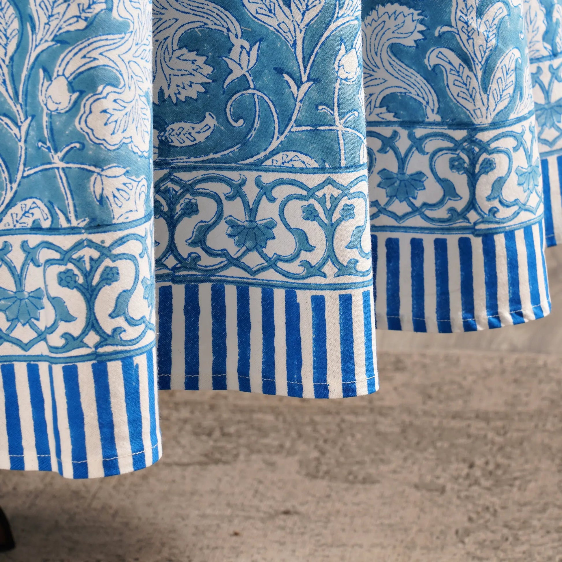 Close-up of blue and white patterned fabric on a wooden surface