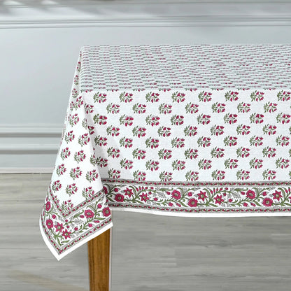 Floral patterned tablecloth on a wooden table with a neutral background