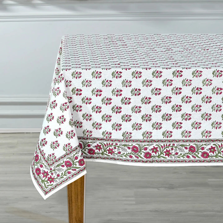 Floral patterned tablecloth on a wooden table with a neutral background