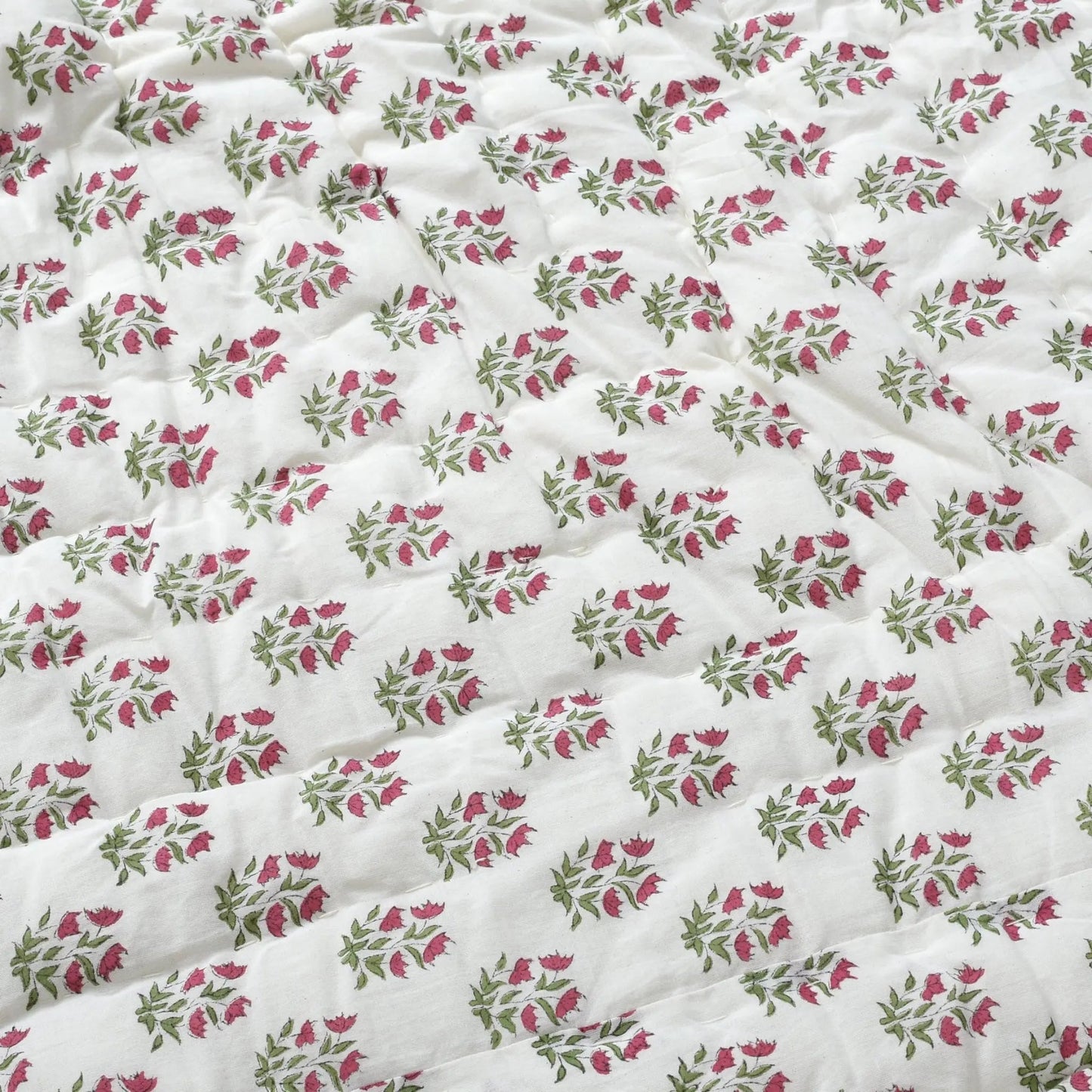 Floral patterned fabric with pink and green flowers on a white background
