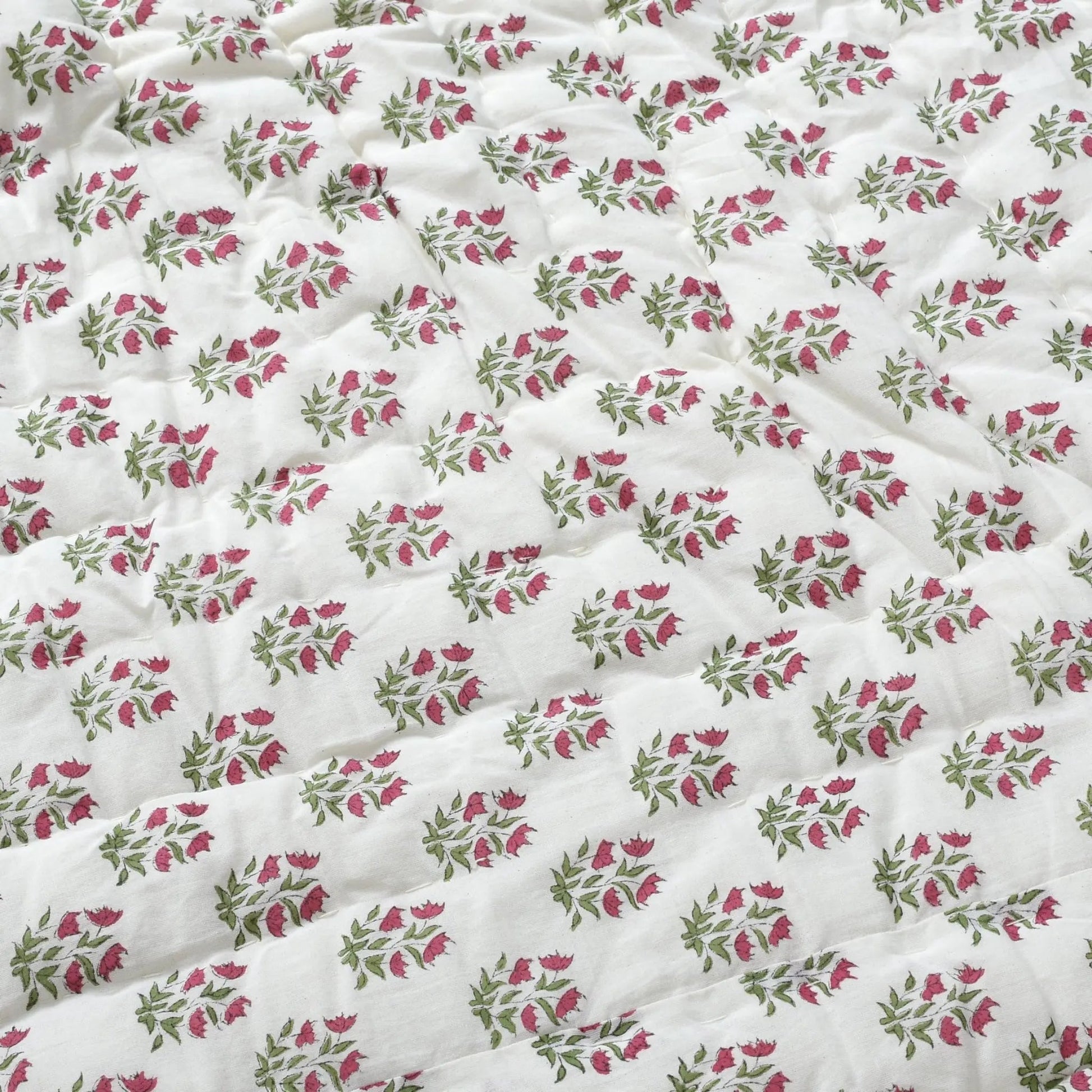 Floral patterned fabric with pink and green flowers on a white background