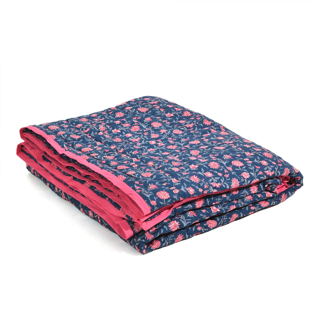 Folded blanket with pink floral pattern on a white background