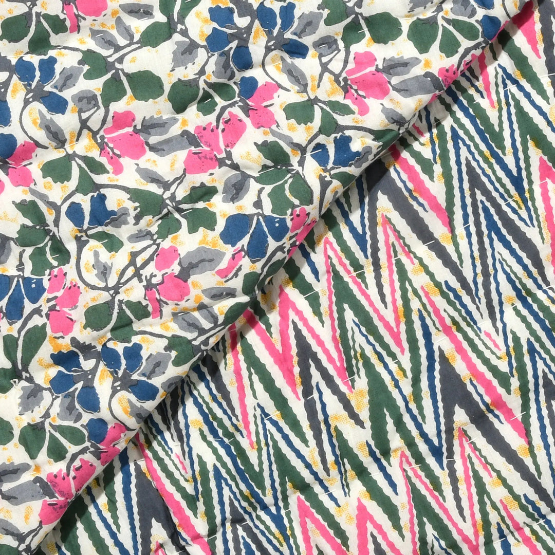 Two pieces of fabric with different patterns, one floral and one geometric, on a white background.