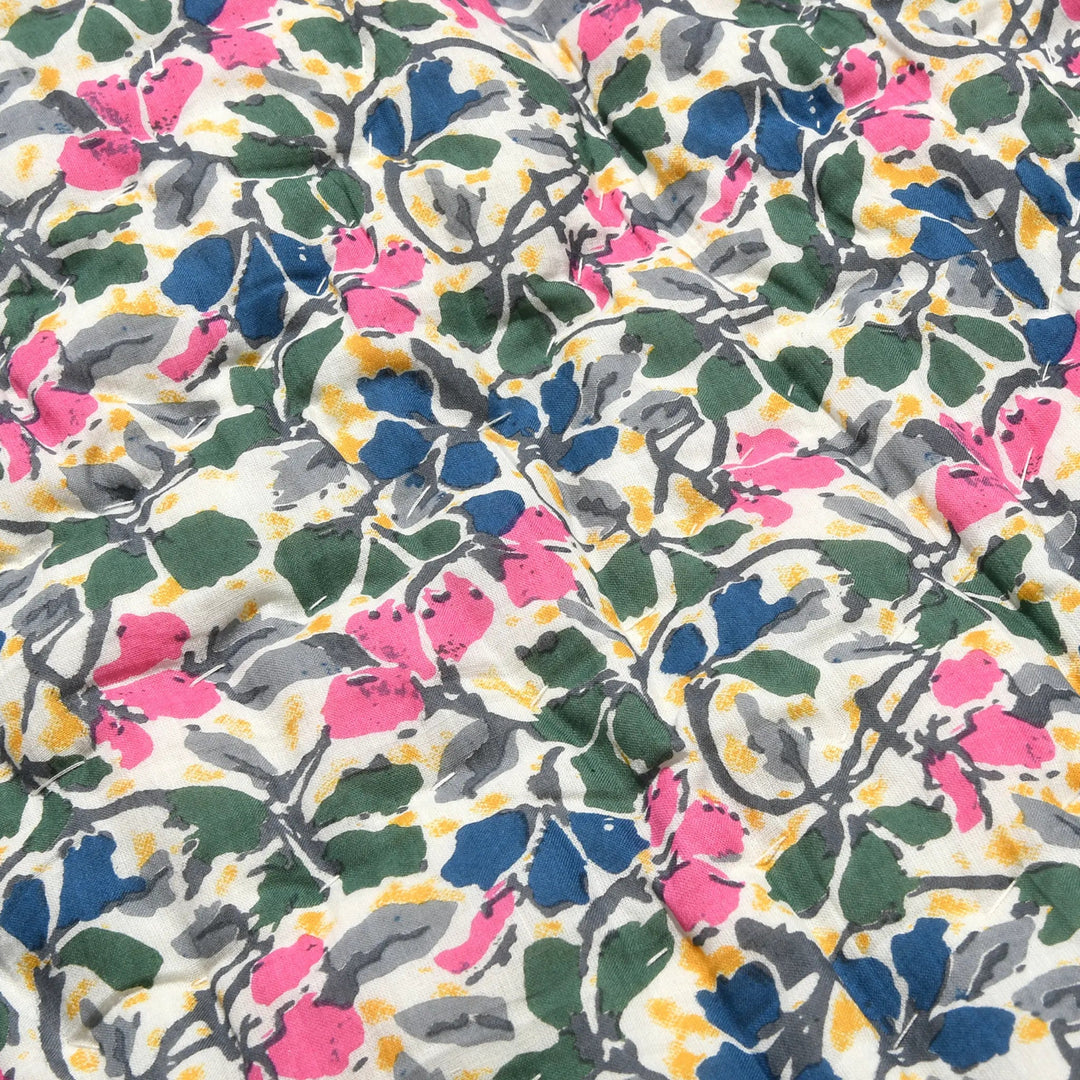 Floral patterned fabric with pink, blue, green, and gray flowers on a white background